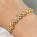 Pulseira Florescer - banhada a ouro amarelo ou platina com zircônias em forma de flores