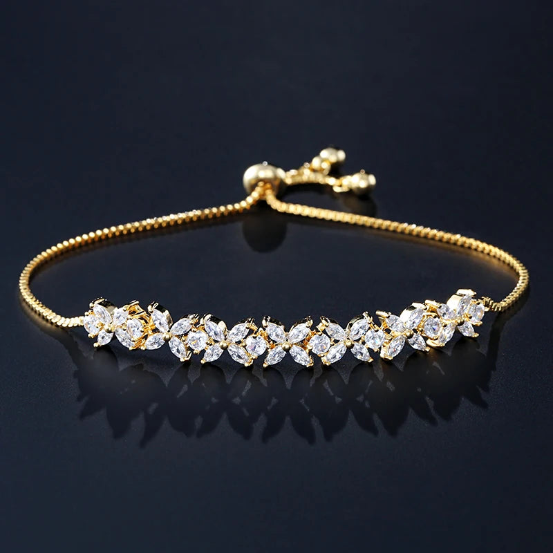 Pulseira Florescer - banhada a ouro amarelo ou platina com zircônias em forma de flores